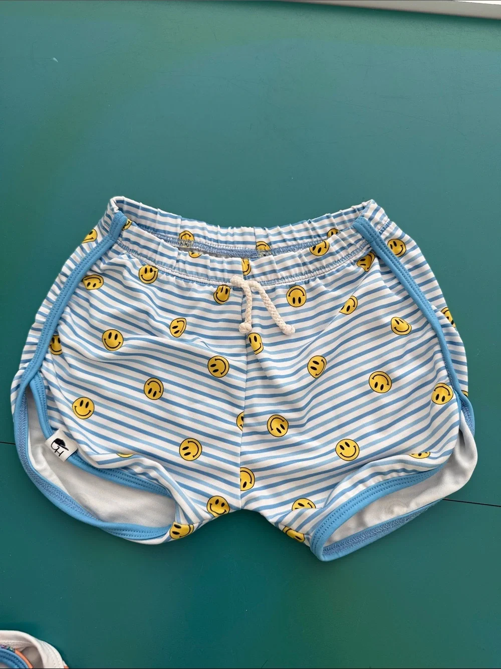 Kids Light Blue Stripe Swim Trunks with Yellow Smile Print